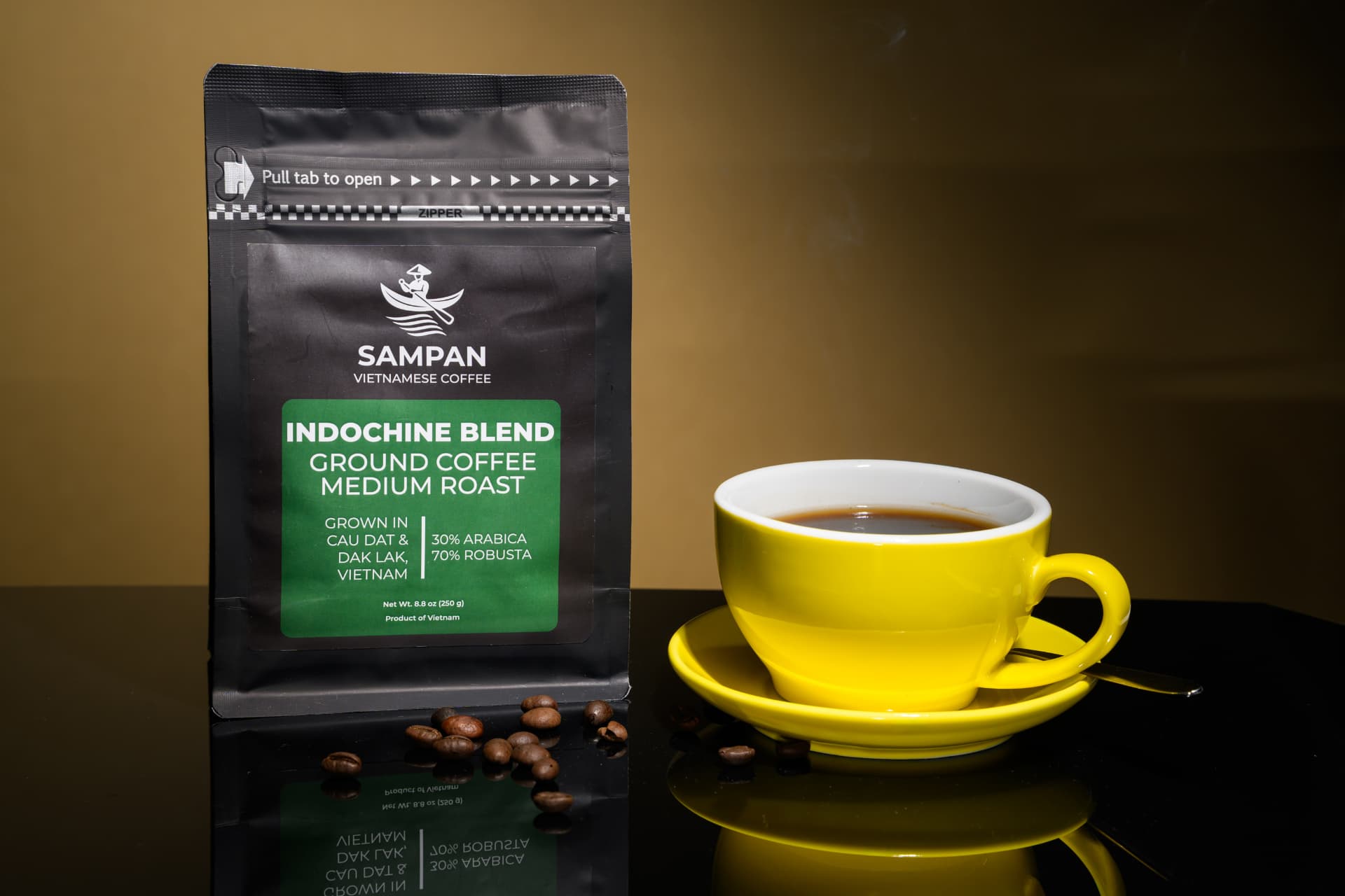 Sampan Indochine Blend coffee bag standing beside a yellow cup of brewed Vietnamese coffee