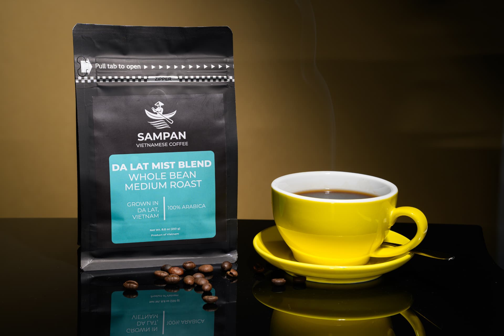 Sampan Da Lat Mist Blend coffee bag standing beside a yellow cup of brewed Vietnamese coffee