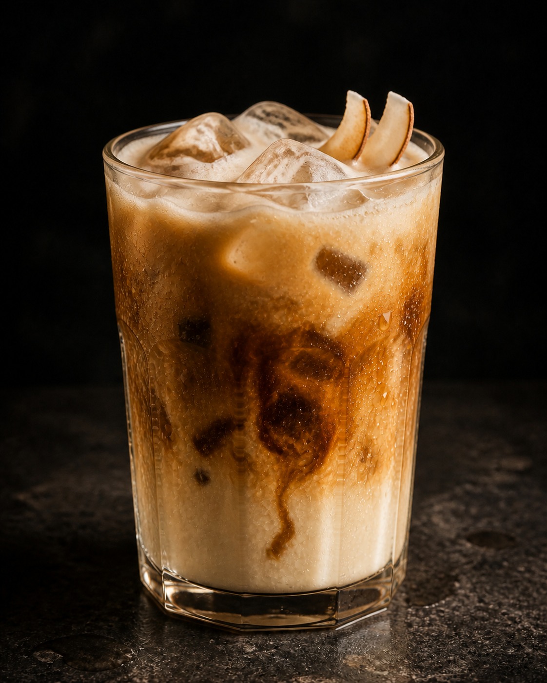 Blended coconut Vietnamese iced coffee in a tall glass, garnished with two slices of coconut